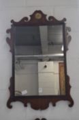 A mahogany fretwork framed wall mirror.