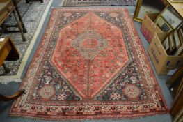 A modern Persian rug, red ground with stylised decoration 250cm x 165cm.