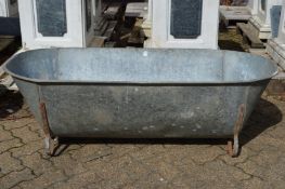 A large galvanised bath/planter.