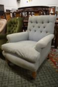 A Victorian button upholstered deep armchair.