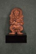 A small Indian bronze god on a marble base.