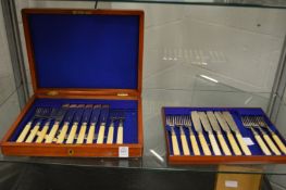 A mahogany cased set of fish knives and forks.