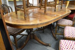 A George III style mahogany twin pedestal dining table with one leaf.