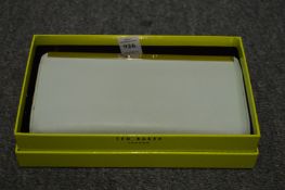 A Ted Baker purse, boxed.