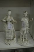 A pair of white glazed continental porcelain figures (af).