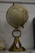A table globe on cast brass stand.