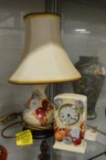 A modern Moorcroft table lamp decorated with butterflies and a matching desk clock.