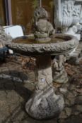 A composite garden bird bath complete with squirrel.