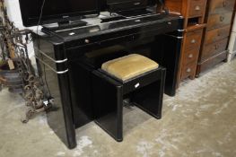 An Eavestaff art deco design mini piano with stool.