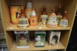 A large quantity of Bells whiskey decanters etc (lacking contents).