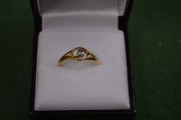 An 18 carat gold and single stone diamond ring.