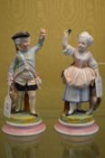 A pair of Dresden figures of a man and woman.