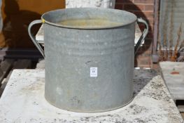 A galvanised twin handled planter.