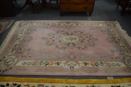 A Chinese carpet, pale pink ground with floral decoration 280cm x 185cm.
