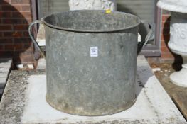 A galvanised twin handled planter.