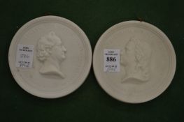 A pair of circular Parian ware relief moulded plaques.
