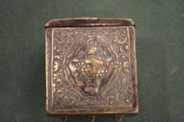An Islamic brass travelling box with embossed and engraved decoration.