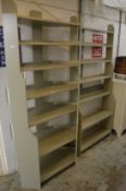 Two pale green painted floor standing shelves.