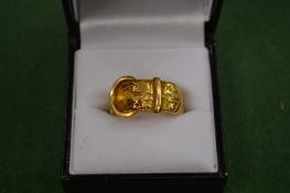 An 18 carat gold buckle ring.