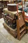 An old step ladder and various suitcases.