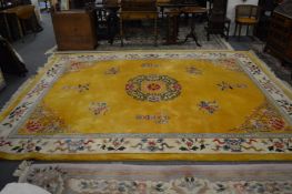 A large Chinese carpet, yellow ground with cream border and floral decoration and other Chinese