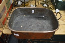 A copper twin handled pan.