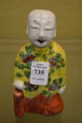 A Chinese pottery model of a boy.