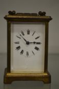 A brass carriage clock.