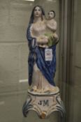 A continental Maiolica tin glazed figure group of Madonna and child.
