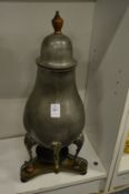 A pewter pear-shaped coffee pot and stand.
