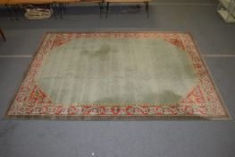 A good large classical design carpet, pale green ground within a red ground border with stylised