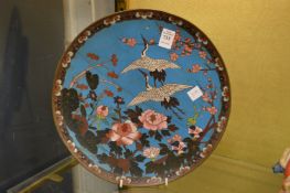 A Japanese cloisonne circular dish decorated with cranes and flowers.