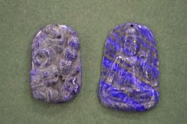 Two Chinese carved lapis pendants.