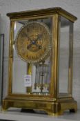 A brass four glass clock.