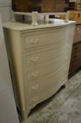 A decoratively painted serpentine fronted five drawer chest.