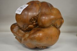 An unusual carved wood crouching figure.