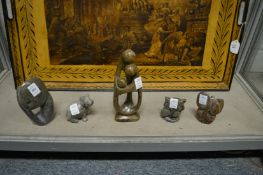 A small collection of carved stone animals and figure groups.