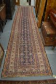 A Melahir runner, dark blue ground with geometric decoration within similar borders 500cm x 100cm.