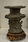 A Japanese bronze vase on stand.