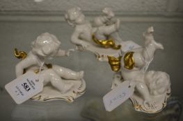 Three small continental porcelain figures of playful cherubs.