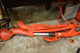 Two electric Flymo strimmers.