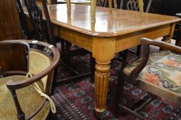 A 19th century mahogany extending dining table with two leaves.
