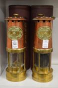 A pair of copper and brass miner's lamps.