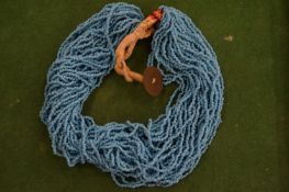 A turquoise bead necklace.