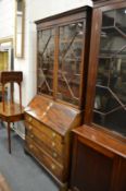 A George III mahogany bureau with associated bookcase upper section.