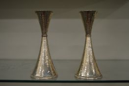 An unusual pair of continental hammered silver candlesticks.
