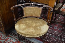 A Edwardian mahogany low occasional chair.