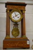 An inlaid rosewood portico mantel clock.