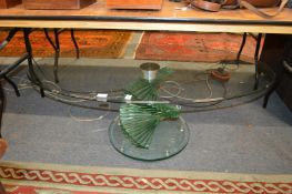 A stylish glass oval coffee table with stepped base.