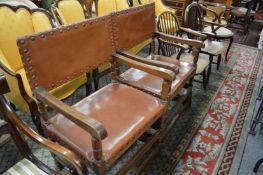 A pair of oak framed armchairs.